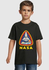 Black t-shirt featuring a NASA logo display with a space shuttle design, yellow text, and colorful space-themed artwork.