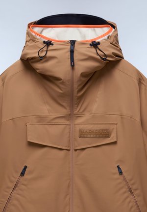 Bruine waterdichte jas met capuchon, voorzien van een rits aan de voorkant, borstzak en zwarte accenten. Oranjekleurige binnenvoering en verstelbare trekkoorden.