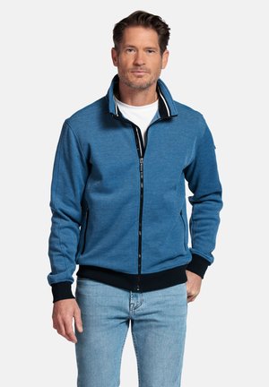 Zip-front jacket in blue fabric, features a high collar with striped accents, long sleeves, and ribbed cuffs and hem.