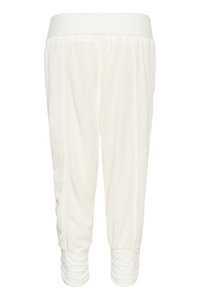 Vita cropped byxor med elastisk midja och ribbade muddar. Tillverkade av ett mjukt tyg, med sid sömmar för en strömlinjeformad look.