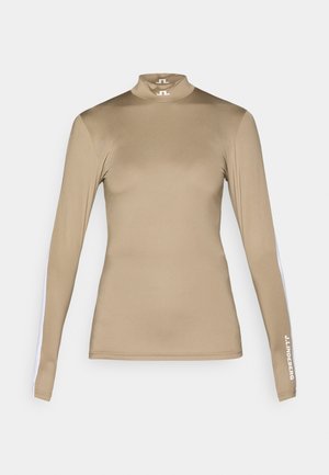 Camisola de mangas longas em tons de beje, feita de um tecido suave. Apresenta um colarinho alto e riscas laterais brancas com detalhe do logo na manga direita.