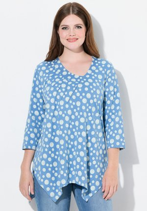 Blaue Tunika mit weißen Punkten, mit Dreiviertelärmel, V-Ausschnitt und asymmetrischem Saum. Hergestellt aus einem weichen Stoff mit strukturiertem Finish.