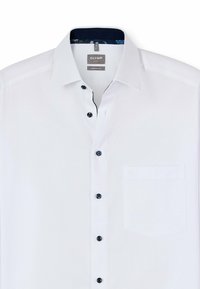 Weißes Hemd im Komfortschnitt mit schwarzen Knöpfen, einer Brusttasche und einem gemusterten Kragenfutter. Glatte Textur ohne Muster.