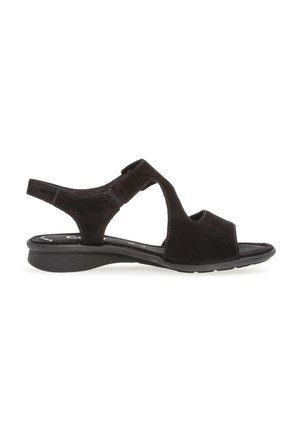 Sandales en daim noir avec une pointe ouverte, un design à découpes, une sangle arrière réglable et un talon compensé bas. Semelle intérieure texturée pour le confort.