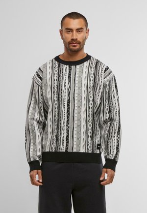 Black and gray patterned sweater with vertical stripes, ribbed cuffs and hem, and a round neckline. Made of textured knit material.