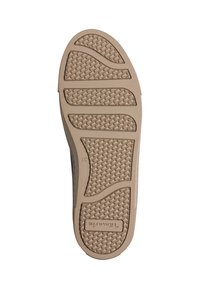 Semelle de chaussure beige avec motif de grip texturé et le nom de la marque "Tamaris" embossé près de la zone du talon.