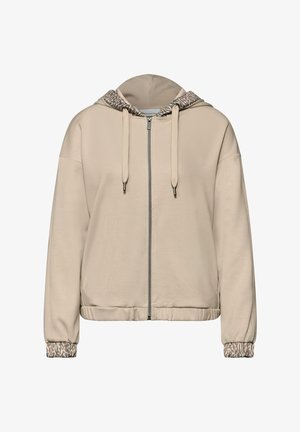 Sweat à capuche beige zippé avec une capuche doublée en imprimé léopard, des poignets côtelés et une coupe décontractée. Confectionné en tissu doux et texturé.