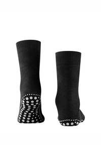 Musta tummaasukka, jossa on resorikuvio ja pohjassa pistekuvioinen kuminen pitoalusta. Suunniteltu vakauteen keskipituisella varrella.