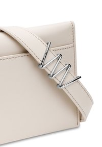 Light beige leather handbag with matching strap featuring a shiny silver zigzag metal buckle detail.
