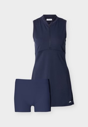 Ärmelloses sportliches Kleid in Marineblau mit Reißverschluss vorne und passenden, taillierten Shorts in Marineblau, entworfen für sportliche Aktivitäten.