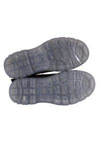 Suelas de goma transparentes con patrones de tracción multidireccional, que presentan formas geométricas y áreas texturizadas para mayor agarre y durabilidad.