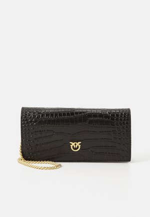 Black faux crocodile print clutch bag, featuring a gold chain strap and logo accent, with a rectangular shape and glossy texture.