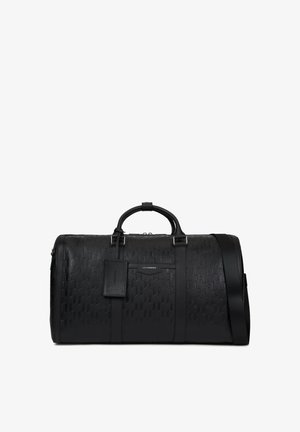 Μαύρη δερμάτινη τσάντα duffel με ανάγλυφο σχέδιο, κοντές λαβές, αποσπώμενο ιμάντα ώμου και προσαρτημένη ορθογώνια ετικέτα.