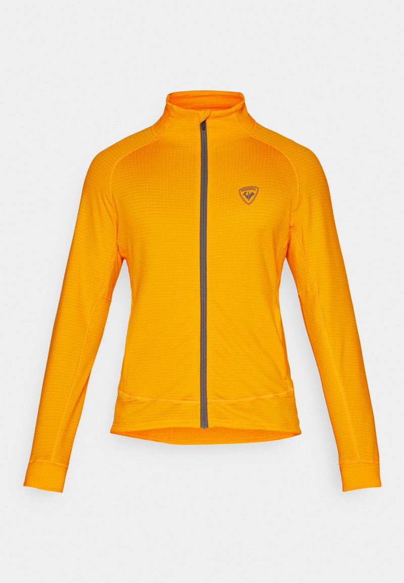 Langdurige mouw, helder oranje jas, met een volledige rits aan de voorkant, textuurstof en een klein logo aan de bovenkant aan de linkerkant.