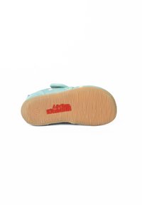 Lichtblauw katoenen schoen met een gestructureerde zool, rubberen tractiepatroon en rood logodetail. Beschikt over een klittenbandsluiting voor gemakkelijk aan- en uittrekken.