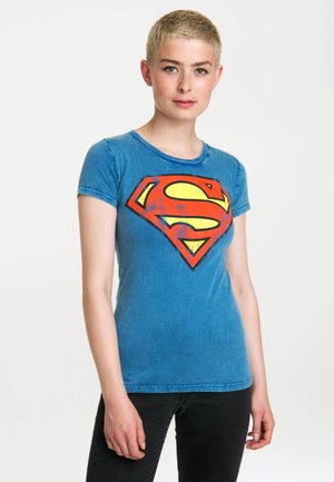 Blue cotton t-shirt with a round neckline and short sleeves features a large red and yellow Superman logo on the front.