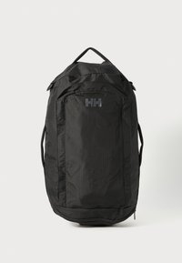 Black backpack with a textured finish, featuring a top handle, adjustable straps, and a front logo. Zippered compartment at the base.