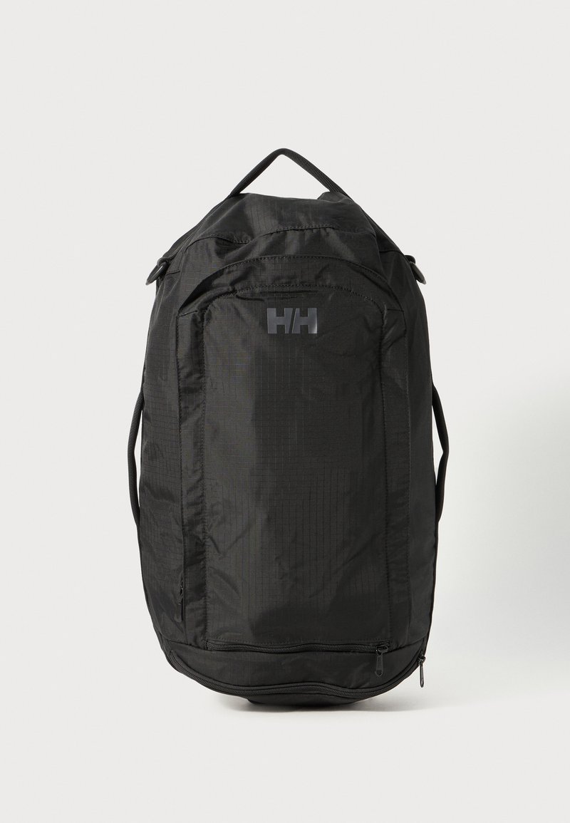 Black backpack with a textured finish, featuring a top handle, adjustable straps, and a front logo. Zippered compartment at the base.