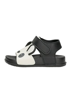 Sandale pour tout-petit noire et blanche avec motif visage de panda, bride ajustable et semelle texturée pour un maintien sûr et un confort optimal.