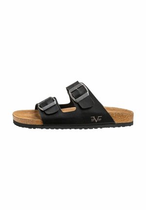 Sandales noires avec deux boucles réglables, semelle en liège et semelle extérieure en caoutchouc texturé. Présente un logo embossé et un design à bout ouvert.