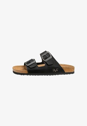 Sandales noires avec deux boucles réglables, semelle en liège et semelle extérieure en caoutchouc texturé. Présente un logo embossé et un design à bout ouvert.