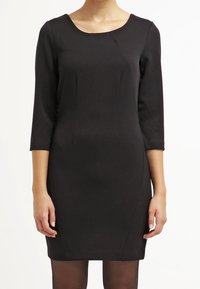 Black knee-length dress with three-quarter sleeves, a scoop neckline, and a fitted silhouette, made from smooth, textured fabric.