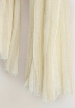 Kevyt, teksturoitu hartiahuivi pehmeässä kerman sävyssä, jossa hienovaraiset vaakaraidat. Hapsutetut reunat tuovat ilmavan ja laskeutuvan ilmeen.