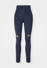 Marinblå sportleggings tillverkade av elastiskt material, med hög midja, guldiga logog detaljer och två sidofickor.