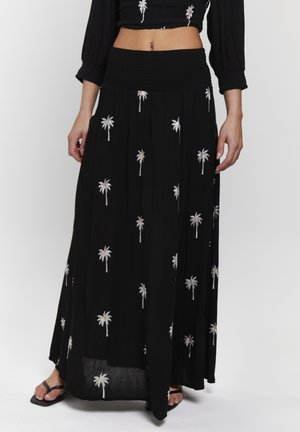 Falda maxi negra con bordado de palmeras en blanco y plata. Presenta una cinturilla con fruncido y una tela ligera para mayor comodidad.