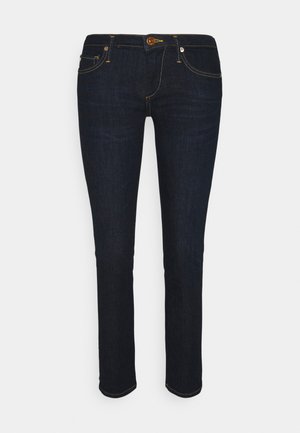 Donkerblauwe spijkerbroek van denim met een slim rechte snit. Heeft gouden stiksels, vijf zakken en een metalen knoop in de taille.