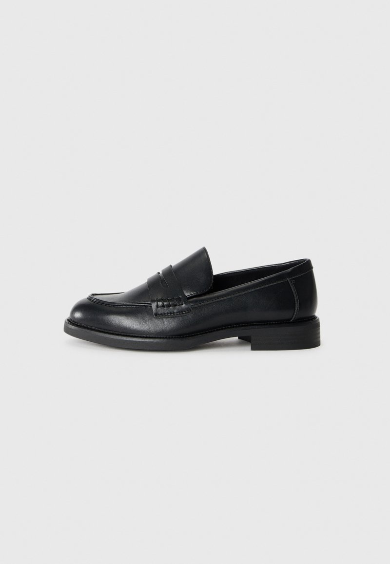 Black leather loafers with a rounded toe, decorative stitching, and a low block heel. Smooth texture and simple design.