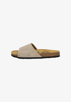 Beige suede slide sandal with a wide crossover strap, cork midsole, and textured black rubber sole. Flat design for easy wear.