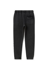 Schwarze Jogginghose aus weichem Stoff, mit elastischem Bund, Seitentasche und schmal zulaufenden Beinen mit minimaler Abnutzung.