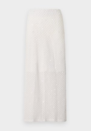 Longue jupe blanche avec un motif discret en losanges et de petits sequins éparpillés, présentée sur un fond gris uni.