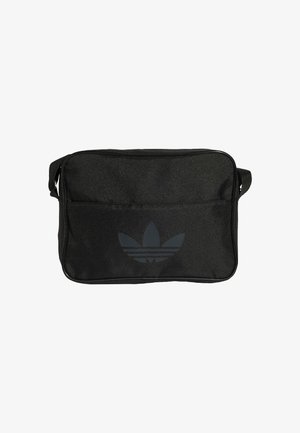 Sac d'épaule rectangulaire noir avec le logo trèfle Adidas et une bandoulière réglable, poche avant zippée, fond uni.