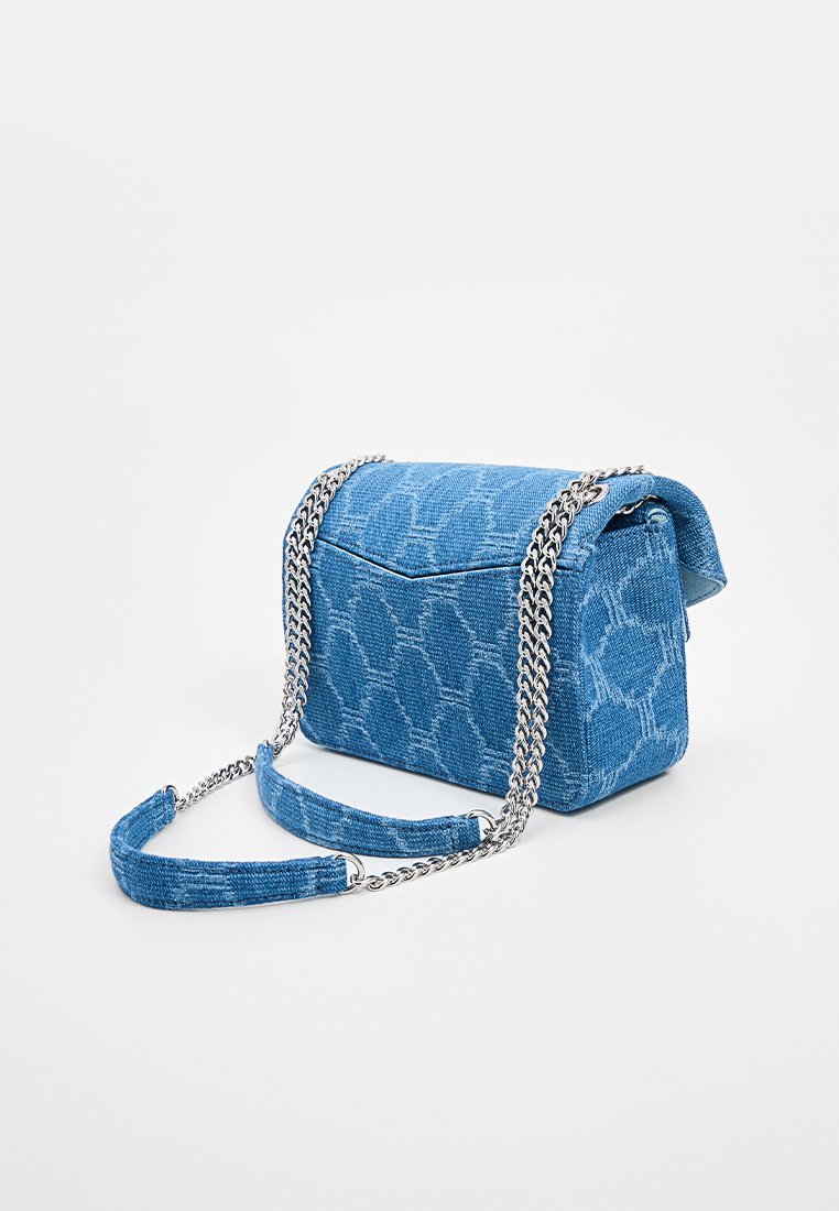 Blue denim shoulder bag with a textured pattern, rectangular shape, silver chain strap, and a flap closure.
