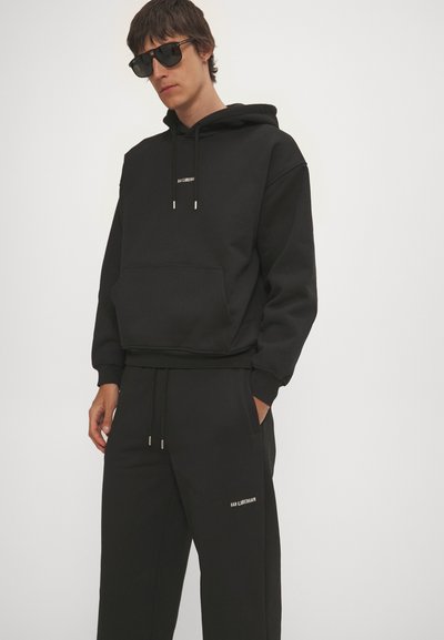 Han Kjøbenhavn DAILY UNISEX - Tracksuit bottoms - black
