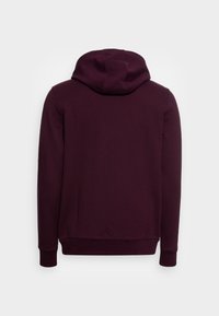Bordeauxkleurige hoodie met een trekkoordcapuchon, lange mouwen en ribgebreide manchetten. Glad, gestructureerde stof met een ontspannen pasvorm. Achteraanzicht weergegeven.