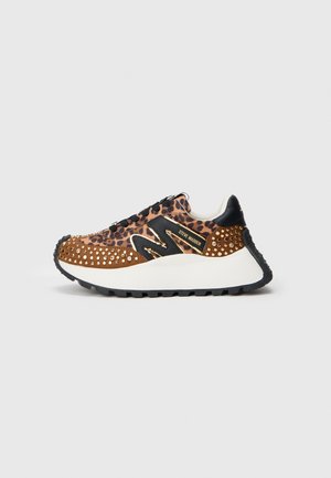 Leopard print sneaker with brown suede, black accents, and metallic studs. Features a chunky white midsole and textured black rubber outsole.