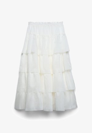 Jupe midi blanche à volants superposés avec taille élastique, présentant plusieurs couches horizontales volantées et un design fluide.