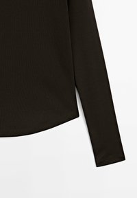 Long-sleeve top in dark brown fabric, featuring a smooth texture, rounded hem, and fitted sleeves. Minimalist design with no patterns or embellishments.