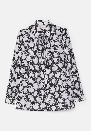 Svart og hvit bluse med blomster mønster, lange ermer, krage og en sløyfedetalj ved halsen. Glatt, lett stoff.