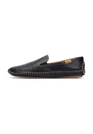 Black slip-on shoe with laser-cut floral design, contrasting stitching, and a smooth leather texture. Rubber sole for grip and flexibility.