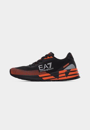 Black and orange athletic sneaker with EA7 Emporio Armani logo and "Crusher" text on the sole, designed for running or casual wear.