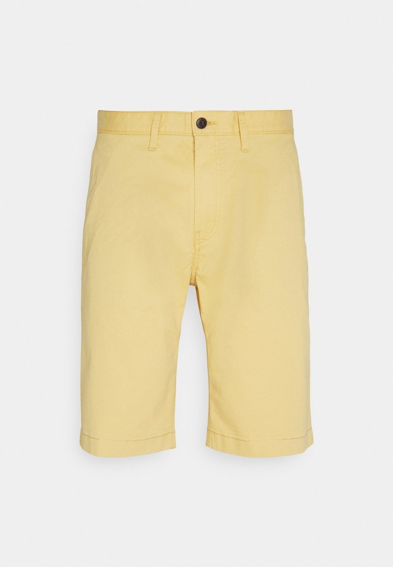 Pantaloni corti di cotone gialli con una vestibilità dritta, orlo risvoltato e chiusura con un solo bottone in vita. Tessuto liscio senza disegni.