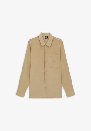 Camicia in corduroy beige con colletto classico, maniche lunghe, chiusura frontale con bottoni e taschino sul petto con toppe logo. Texture liscia.