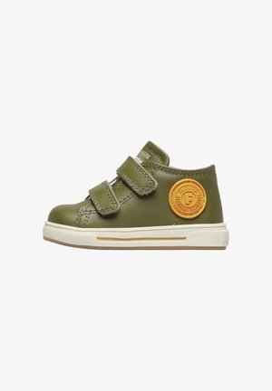 Scarpa verde in pelle con due strap in velcro, punta arrotondata, suola bianca in gomma e accento giallo a forma di cerchio sul lato.