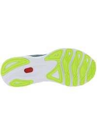 La suela del zapato presenta una base blanca con acentos verdes llamativos y un detalle rojo insertado. Los patrones texturizados mejoran el agarre y la flexibilidad.