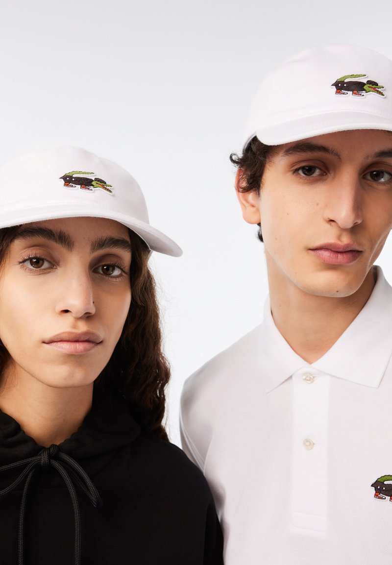 Lacoste LACOSTE X NETFLIX UNISEX Casquette white/sex education