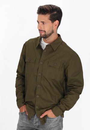 Olijfgroene button-up shirt met twee borstzakken, lange mouwen en een spitse kraag. Gemaakt van stevig fabric met een strakke, op maat gemaakte uitstraling.